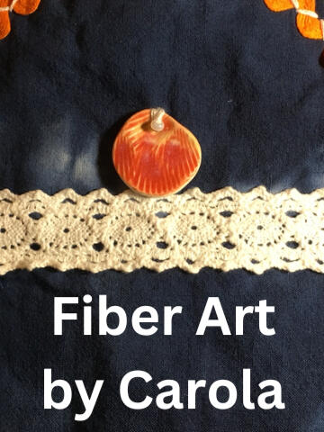 Fiber Art by Carola Logo Photo of glazed porcelain button on indigo dyed fabric with cotton ribbon. Close-up of shawl.